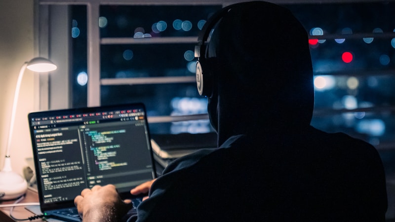 A developer working alone on a laptop late at night