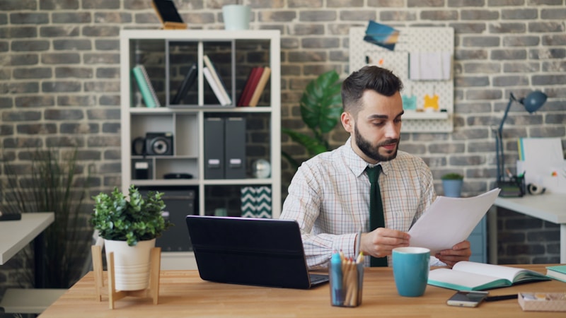 A founder sitting at a desk looking stressed while reviewing information on screen