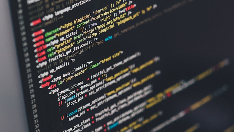 A developer writing code on a monitor