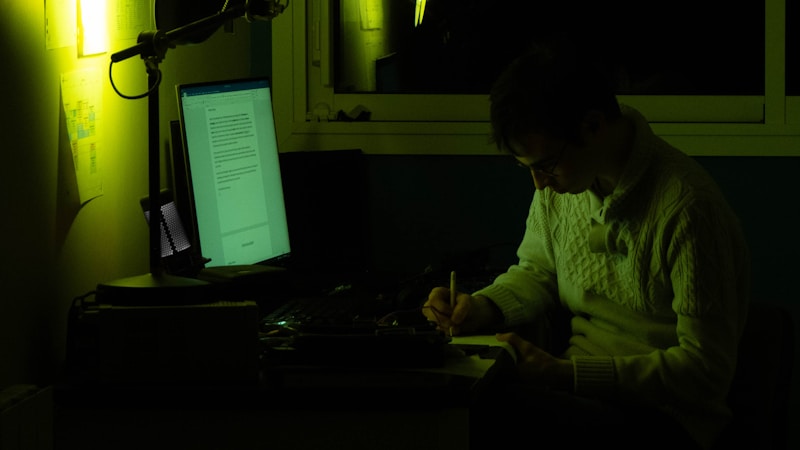 A man focused at a laptop, working alone