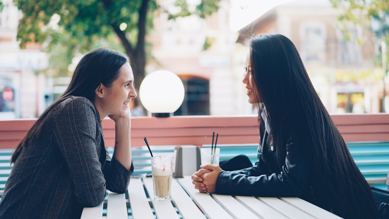 Two founders talking over coffee at a cafe table