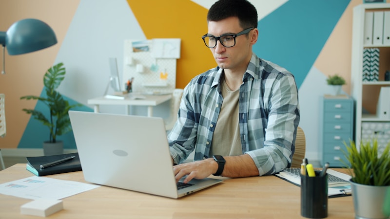 A focused founder typing at a desk, working alone