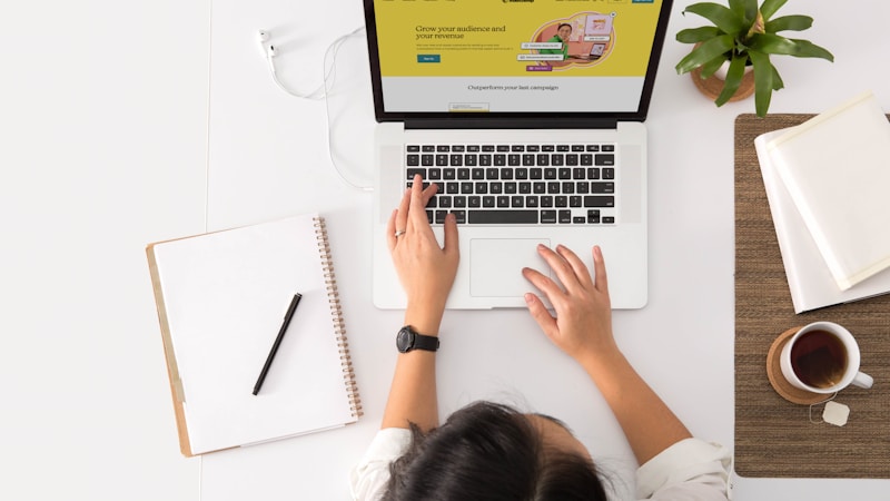 A founder at a desk with a laptop and coffee, thinking