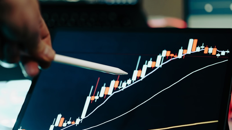 A person reviewing a financial chart on a laptop screen